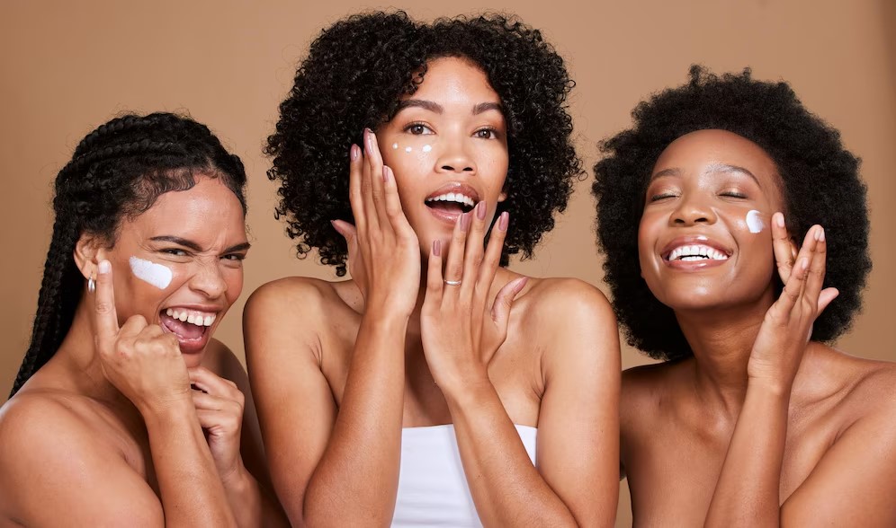 Three women enjoying a joyful skincare routine